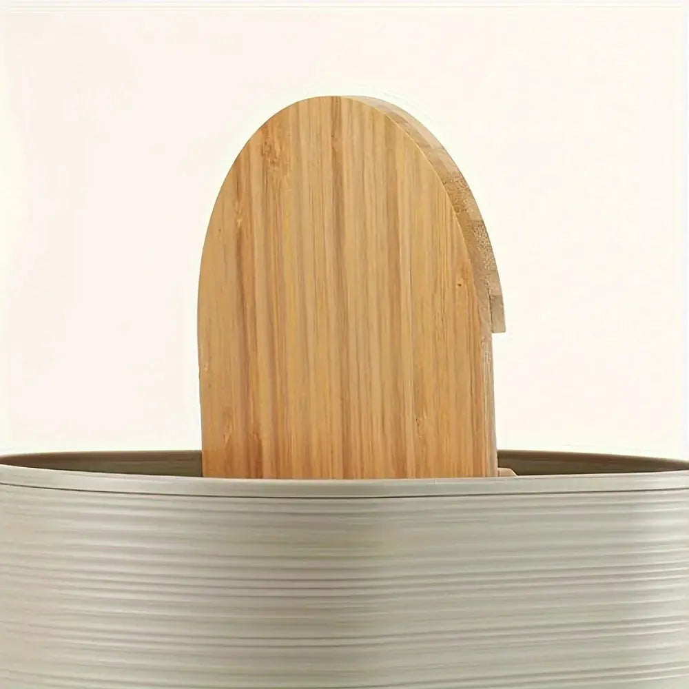 Toothbrush holder in natural wood, part of a bathroom accessories set on a white ribbed countertop basin