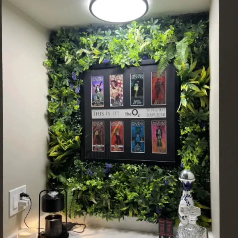 Artificial grass wall panel with green boxwood hedge surrounding a framed poster display