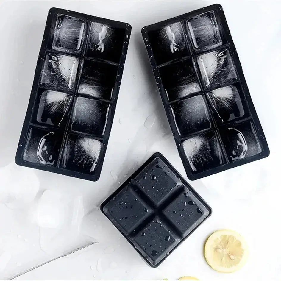 Set of three black silicone ice cube molds for whiskey; square and rectangular grid trays