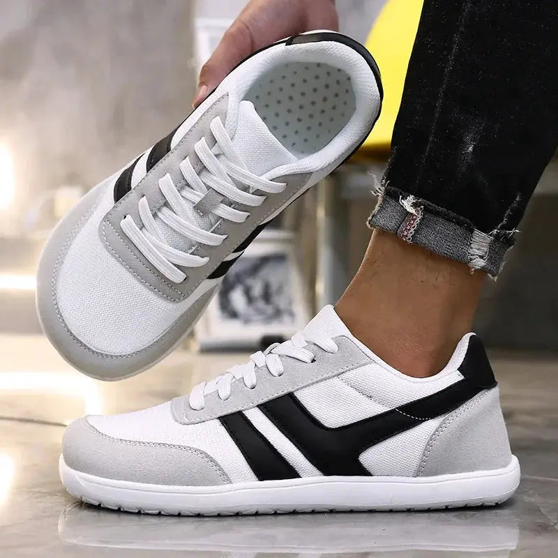 Wide anti-slip running shoes by Simples Market, white with gray overlays and black stripes, lightweight breathable pair