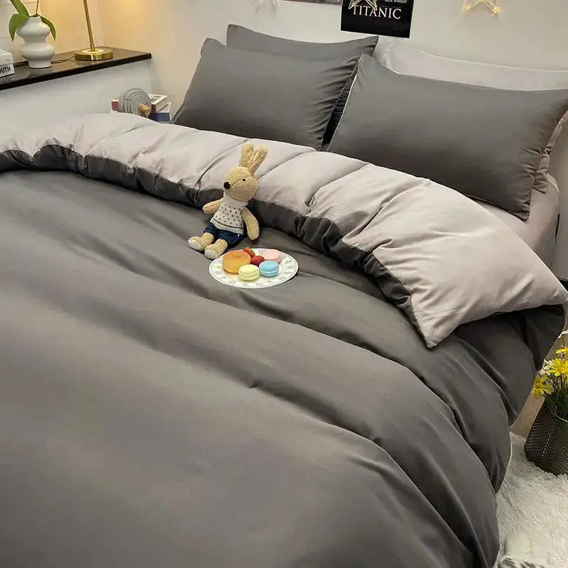 Simples Market Bonenjoy dark gray duvet cover on a bed with pillowcases; plush bunny and macarons nearby.