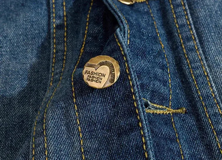 Blue denim sleeveless vest with yellow stitching and a gold metal button.