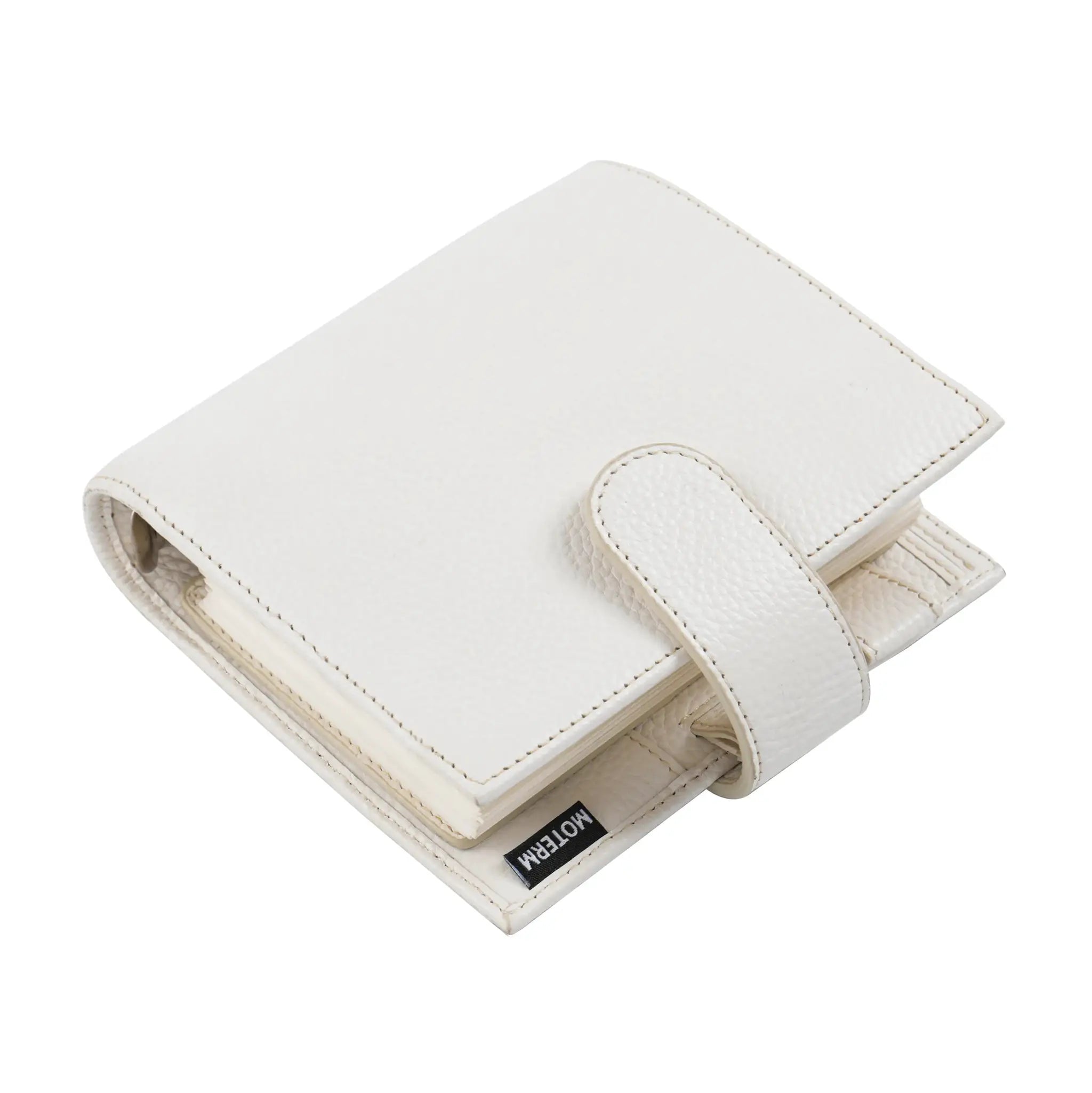 Moterm Luxe 2.0 pocket-size planner in white pebbled leather with strap; Moterm brand tag visible.