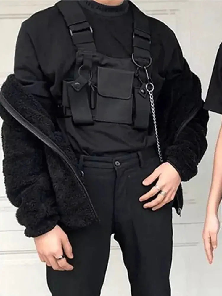 Functional tactical chest bag in black with multiple pockets worn as a chest rig.