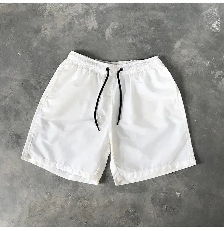 Men's swim shorts, white with black drawstring, knee-length beach trunks.