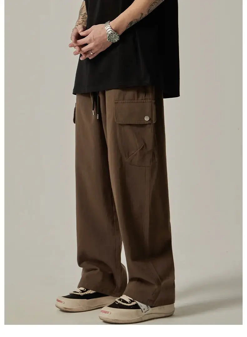 Men's cargo sweatpants in brown, wide-leg drawstring trousers with large pockets.
