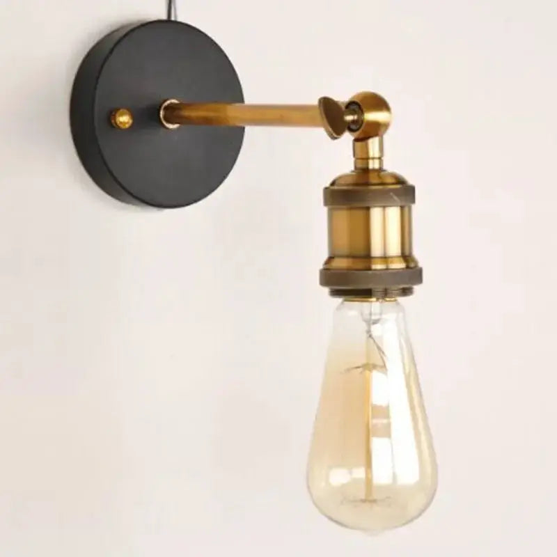 American single-head wall lamp with industrial brass arm and exposed Edison bulb on a black round wall mount