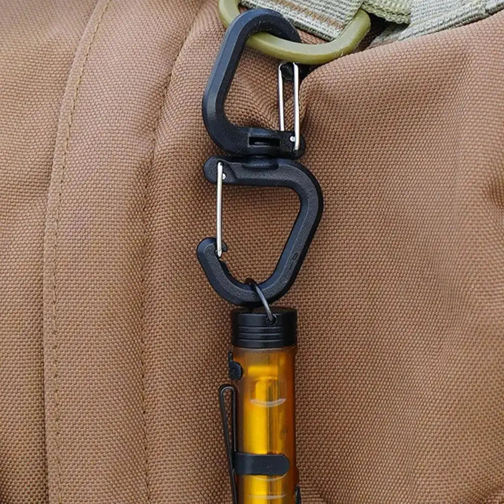 Double clip carabiner with 360° swivel, black, attached to an orange flashlight on a backpack strap