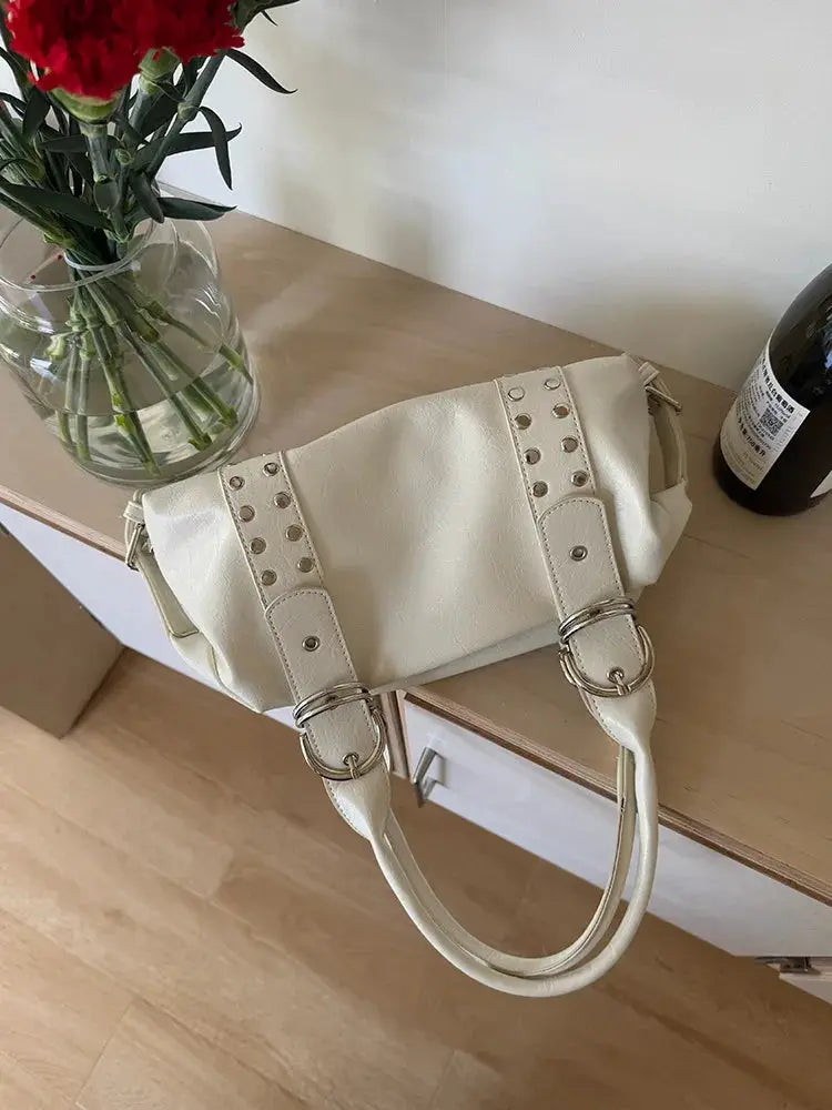 Cream PU leather shoulder bag with riveted straps and metal buckles