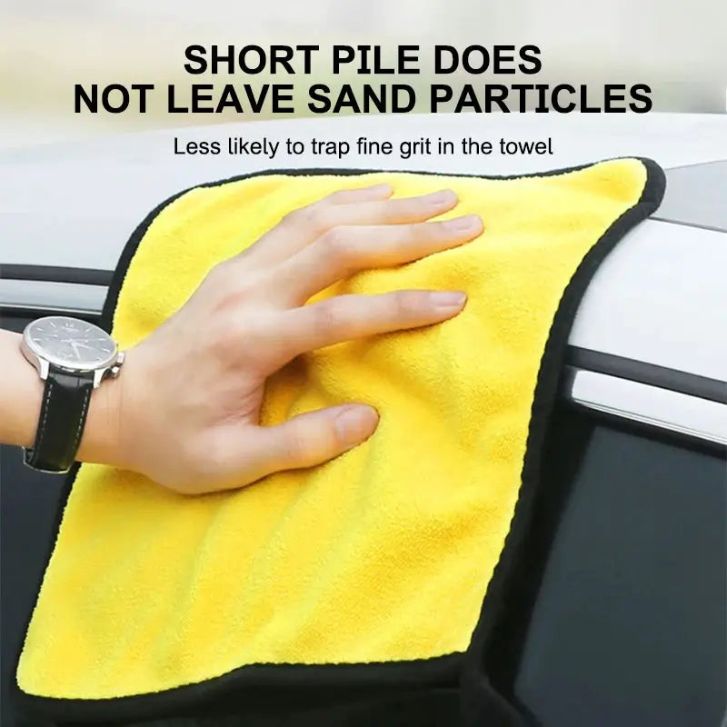 One yellow microfiber car wash towel with black edging for drying and detailing.