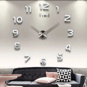 Large 3D wall clock with oversized white numerals and silver hands, modern living room decor