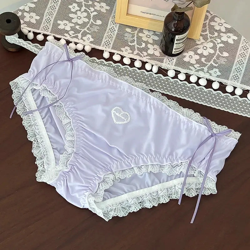 Lavender satin panties with white lace trim, heart embroidery, and side ribbon ties; plus-size by Simples Market