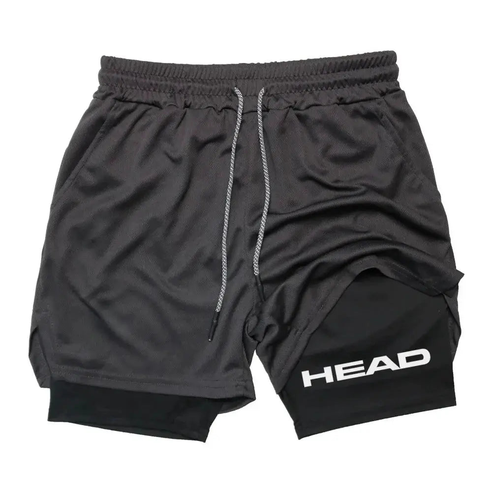 2-in-1 men's running shorts with gray outer and black inner, HEAD logo, drawstring, quick-dry fabric.