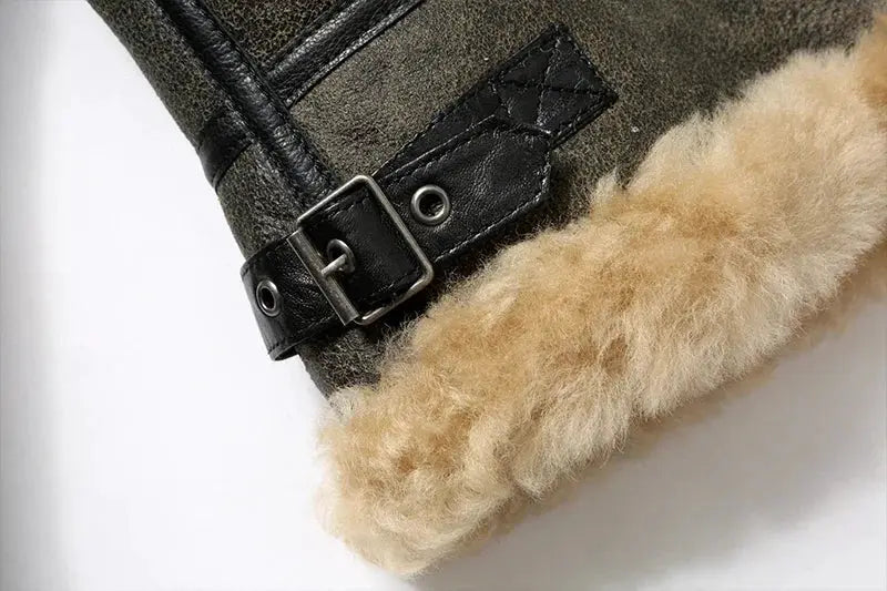 Leather fur jacket cuff with beige shearling lining and metal buckle strap.