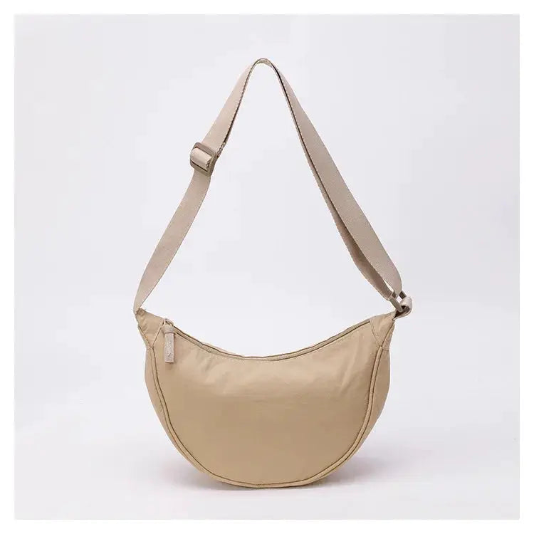 Nylon fabric zipper crossbody bag in beige, crescent-shaped dumpling style with adjustable strap, large capacity