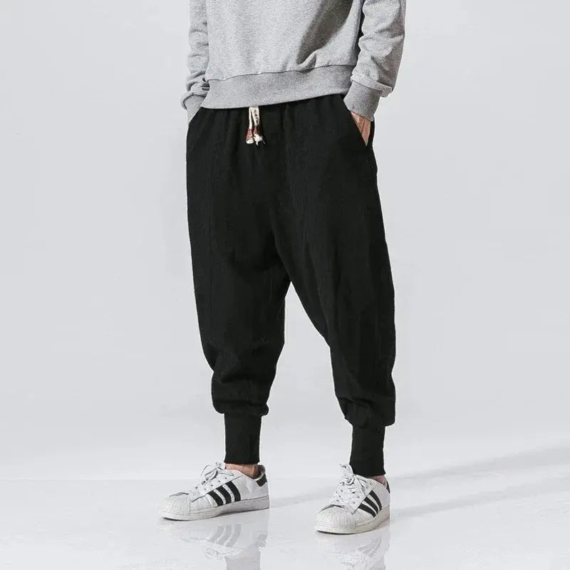 Cotton-linen men's harem pants with drop-crotch, black, cuffed ankles and drawstring waist.