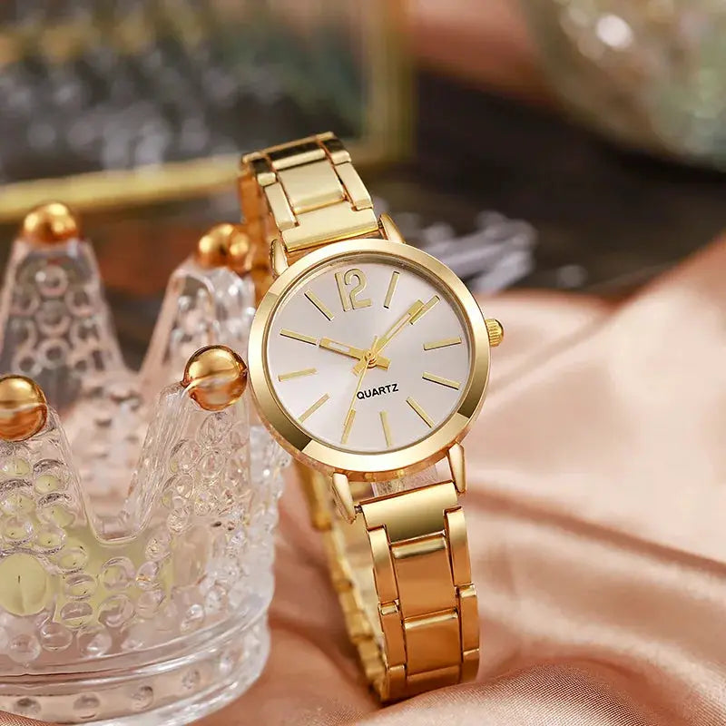 Gold-tone women's wristwatch with a simple white dial and bracelet strap