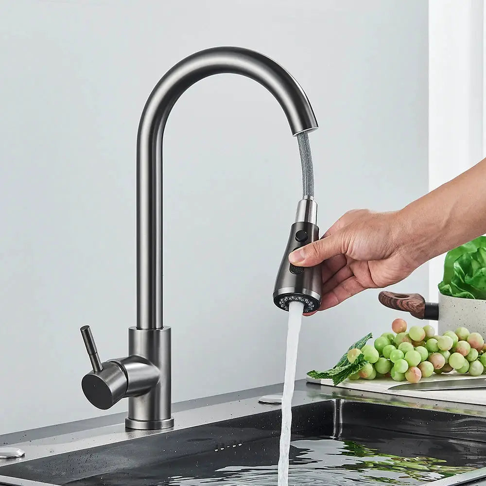 Brushed nickel kitchen faucet with flexible pull-out spray head on a deck-mounted mixer