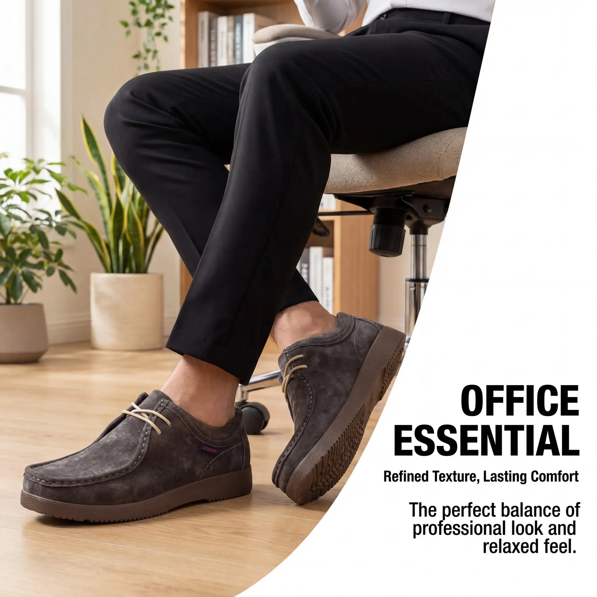 Men's grey suede loafers with hand-sewn moccasin detailing, pair shown on a wooden floor.