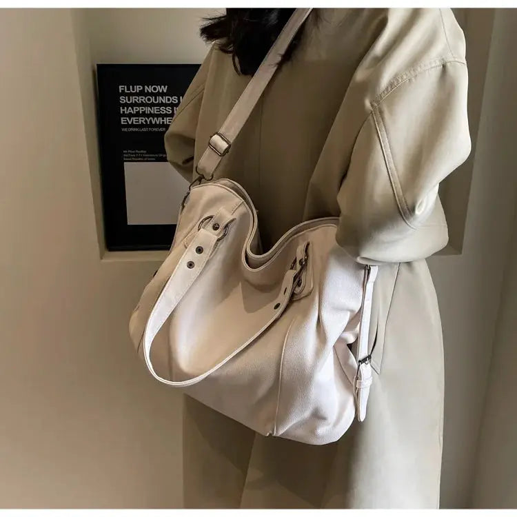 Soft interior compartment shoulder bag in cream PU leather with crossbody strap by Simples Market