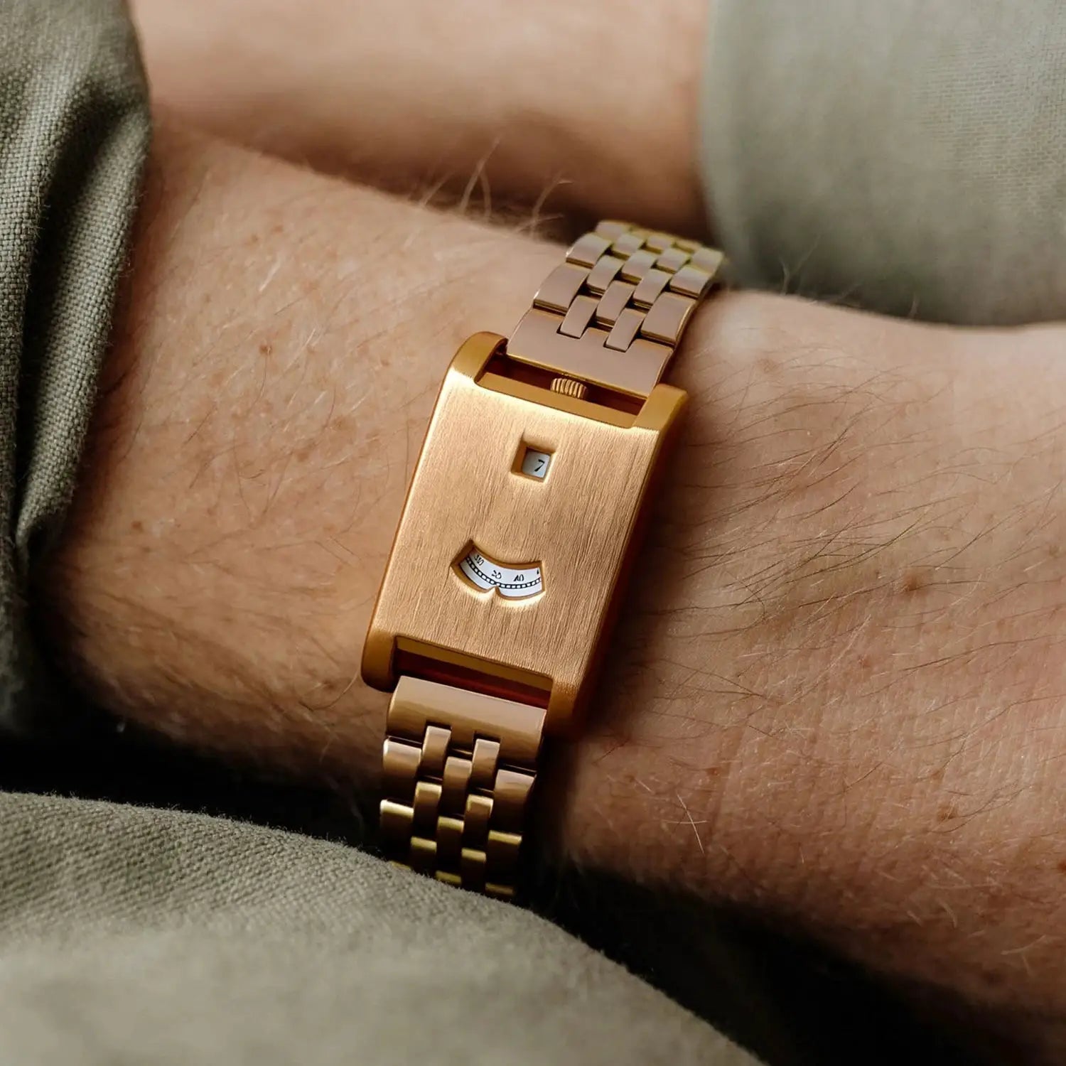 Rose-gold-toned square tank watch for men with a linked bracelet and date window.