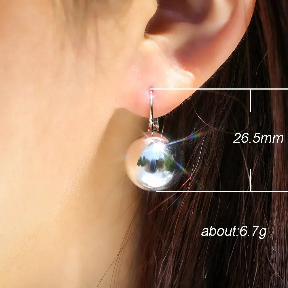 Silver ball drop earring with a polished spherical pendant