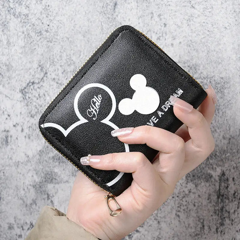 Black wallet with white cartoon mouse-ear outlines and a gold zipper, compact zippered coin purse