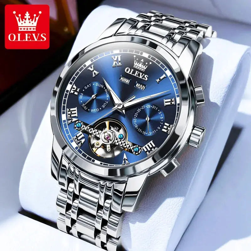 OLEVS stainless steel skeleton automatic wristwatch with blue dial, Roman numerals, dual calendar, exposed flywheel.