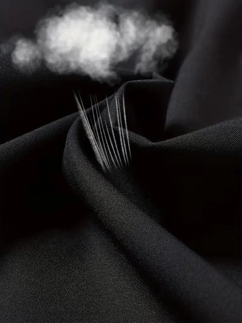 Men's black sports shorts fabric close-up with tight weave and stitching