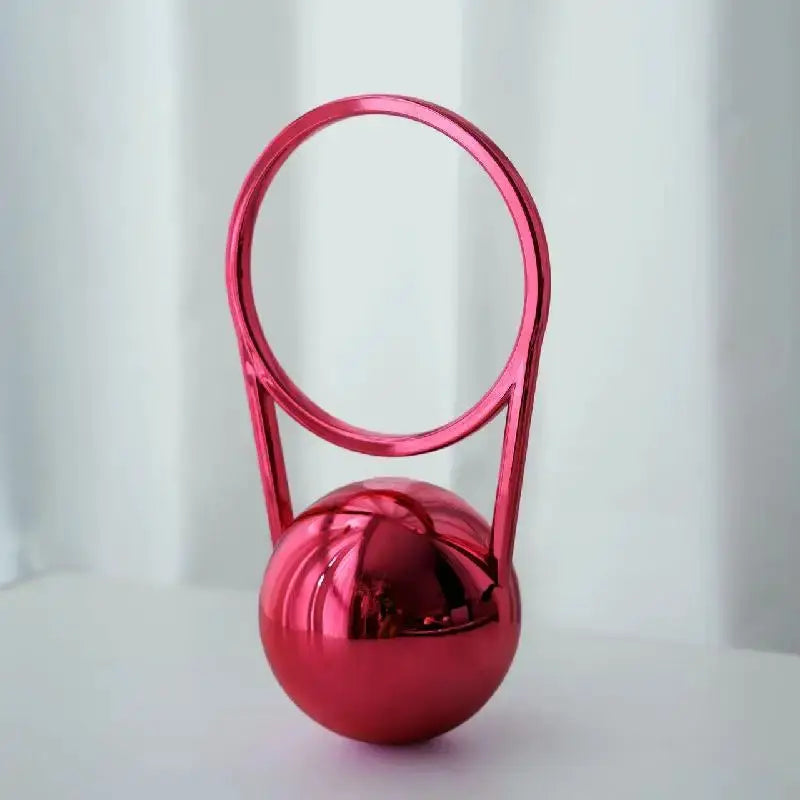 Pink acrylic evening clutch with circular ring handle and spherical base