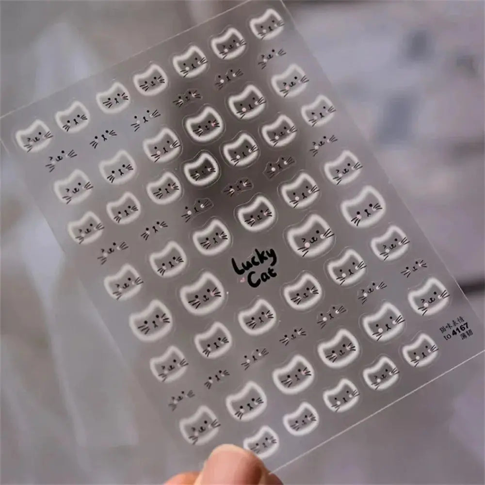 Cat face nail stickers sheet with white halo cat faces and Lucky Cat motif on clear backing