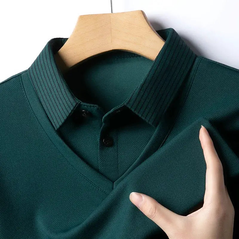 Men's dark green polo shirt on hanger with textured knit fabric, collar, and two-button placket.