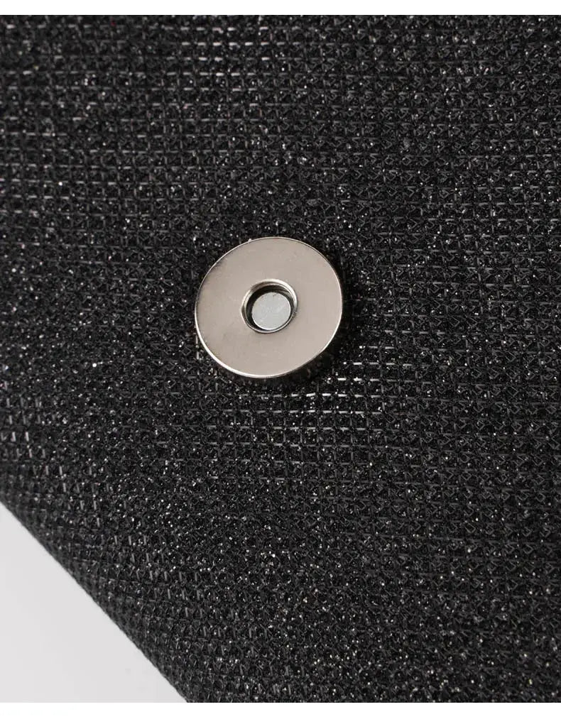 Women envelope evening bag with glittery black fabric and silver round snap closure