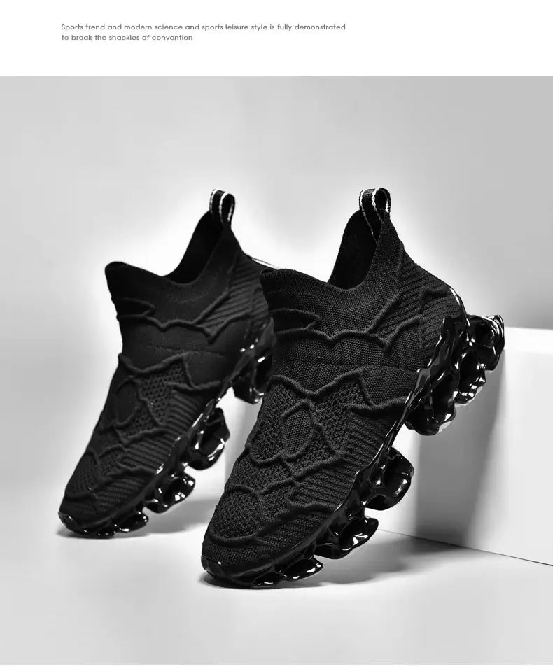Pair of men's black knit sneakers, breathable athletic shoes with a distinctive segmented outsole.