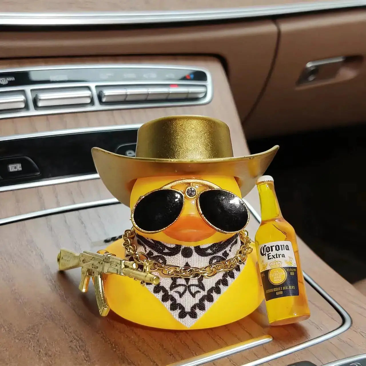 Cowboy rubber duck car ornament in yellow with a gold hat, sunglasses, bandana, chain, and Corona bottle