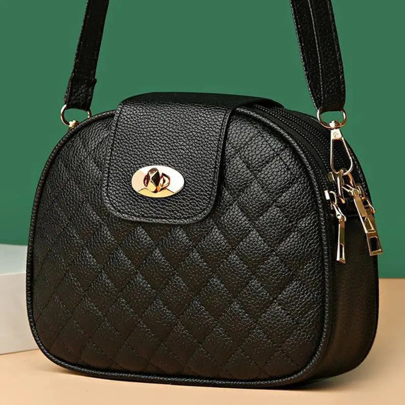 Gentle Compact Quilted Oval Crossbody Bag in black PU leather with gold-tone hardware and multi-pocket zipper storage