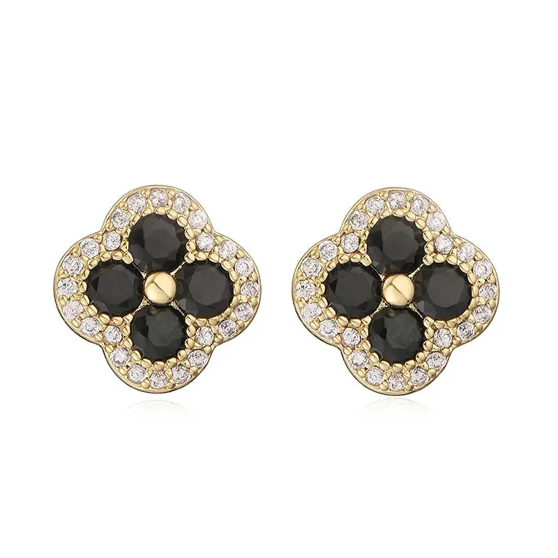 Flower-shaped gold-plated earrings with black CZ stones and surrounding clear crystals, a pair