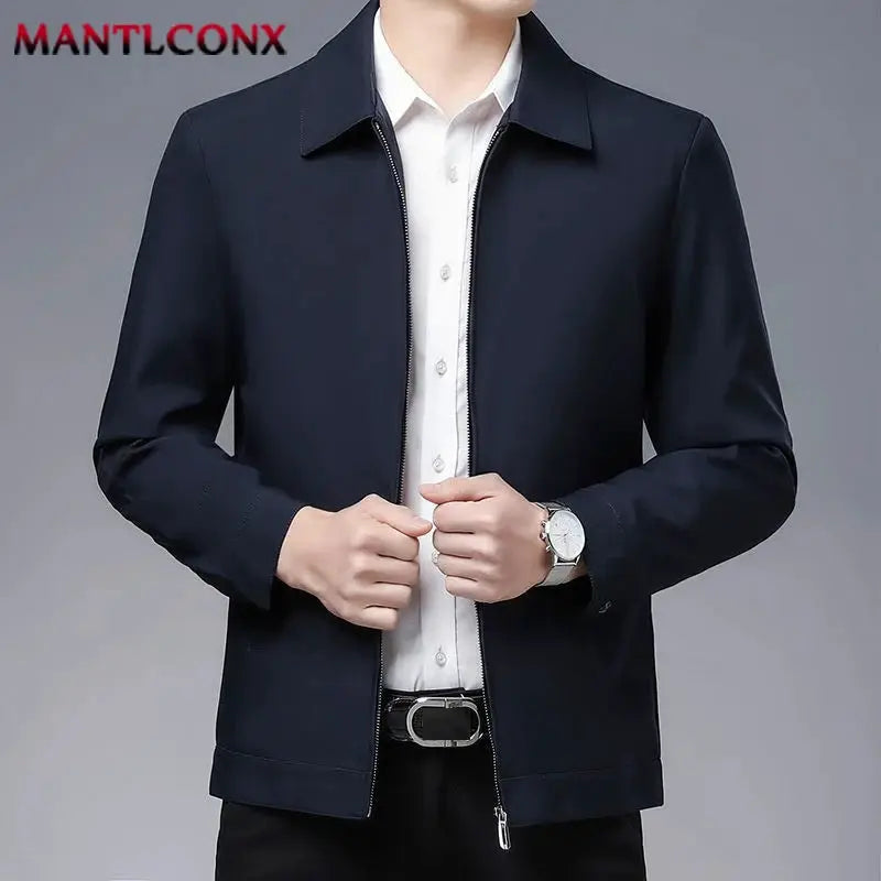 Men's navy zip-front blazer jacket with white shirt; MANTLCONX logo visible