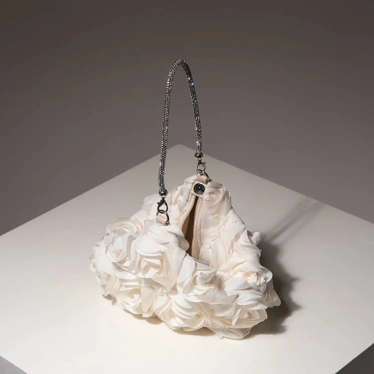 Mini bridal purse by Simples Market; crystal-beaded handle and white fabric floral exterior.