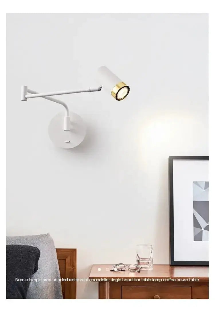 Wall lamp with white cylindrical shade and brass ring, adjustable arm on round wall mount