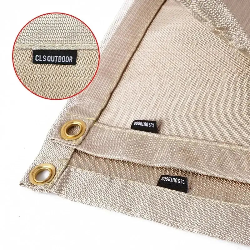 Fireproof fiberglass camping insulation mat in tan with brass grommets and CLS OUTDOOR tag