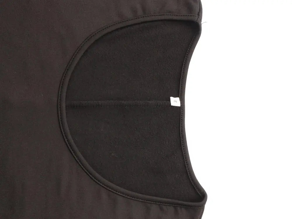 Women's black long-sleeve jumpsuit close-up of inner armhole with size S tag