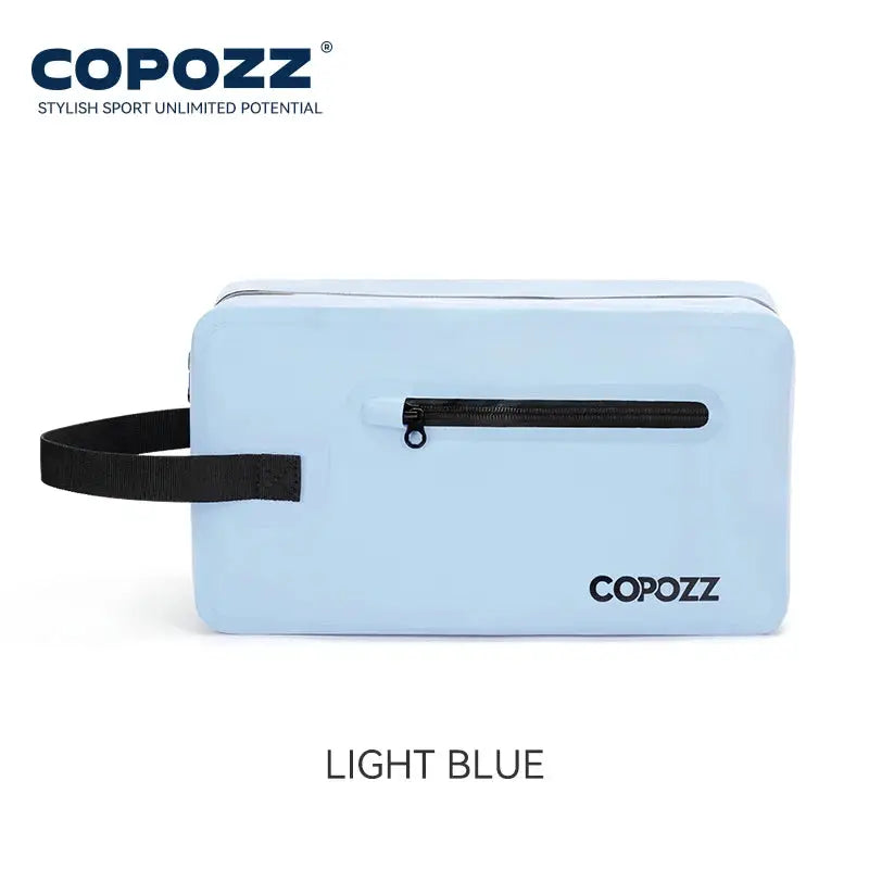 Gym bag in light blue with black zip pocket and black strap; COPOZZ logo visible