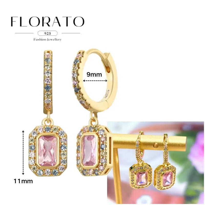 Gold-tone Florato earrings set with pink zircon stones in halo frames; geometric hoop and drop pendant styles