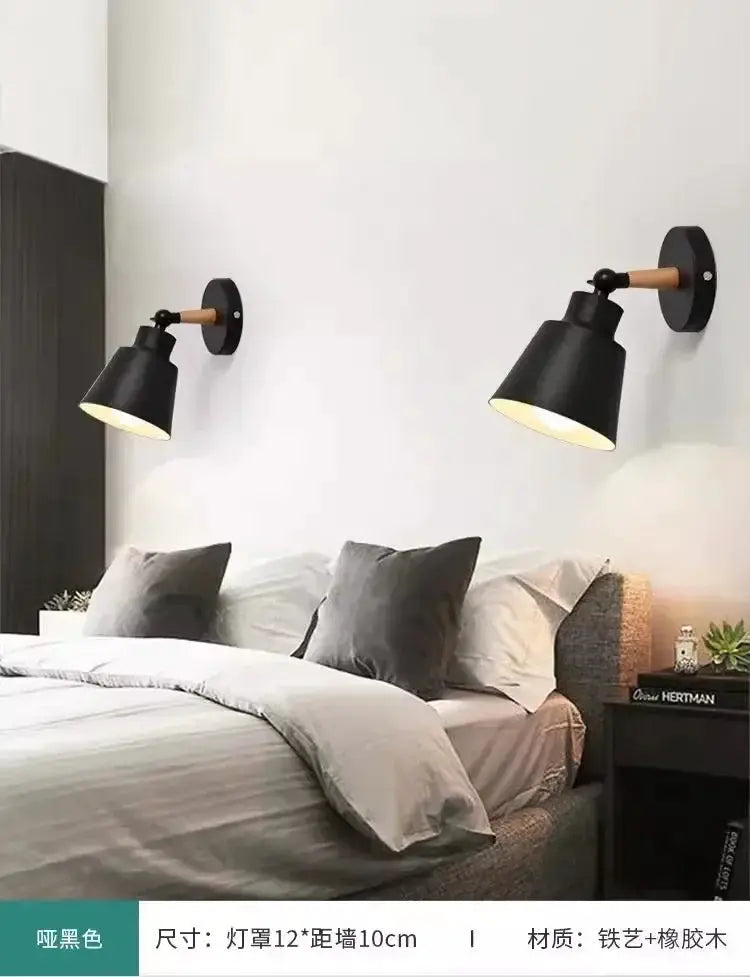 Nordic bedroom wall lamps, two black metal shades with wood arms, LED lighting, mounted over a bed.