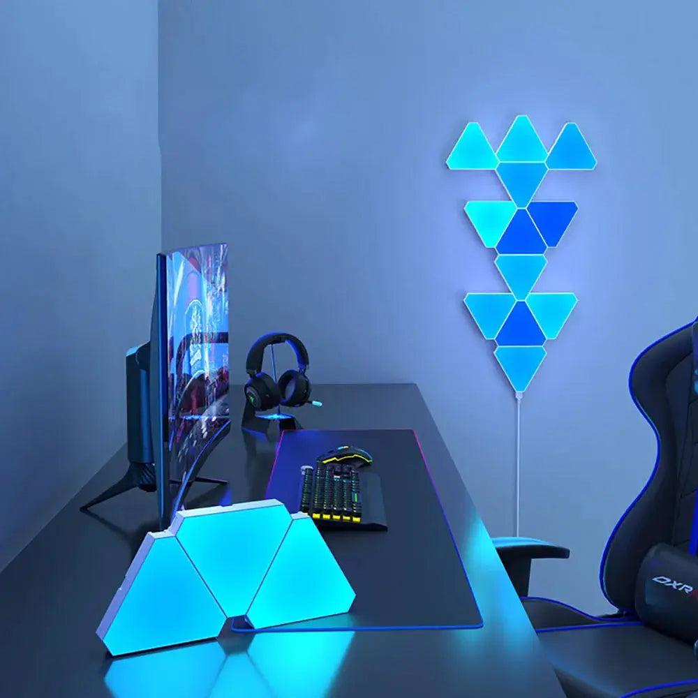 LED triangular RGB lamp set by Simples Market: 2-piece wall panel and desk lamp in blue on a computer desk.