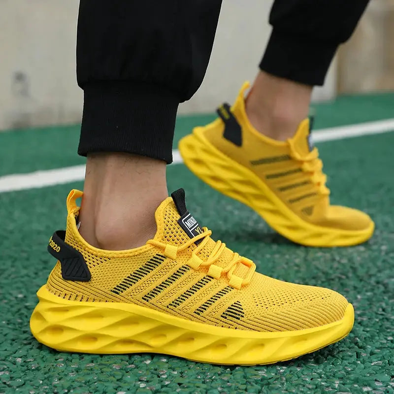 Unisex yellow breathable running sneakers with black accents and a textured chunky sole
