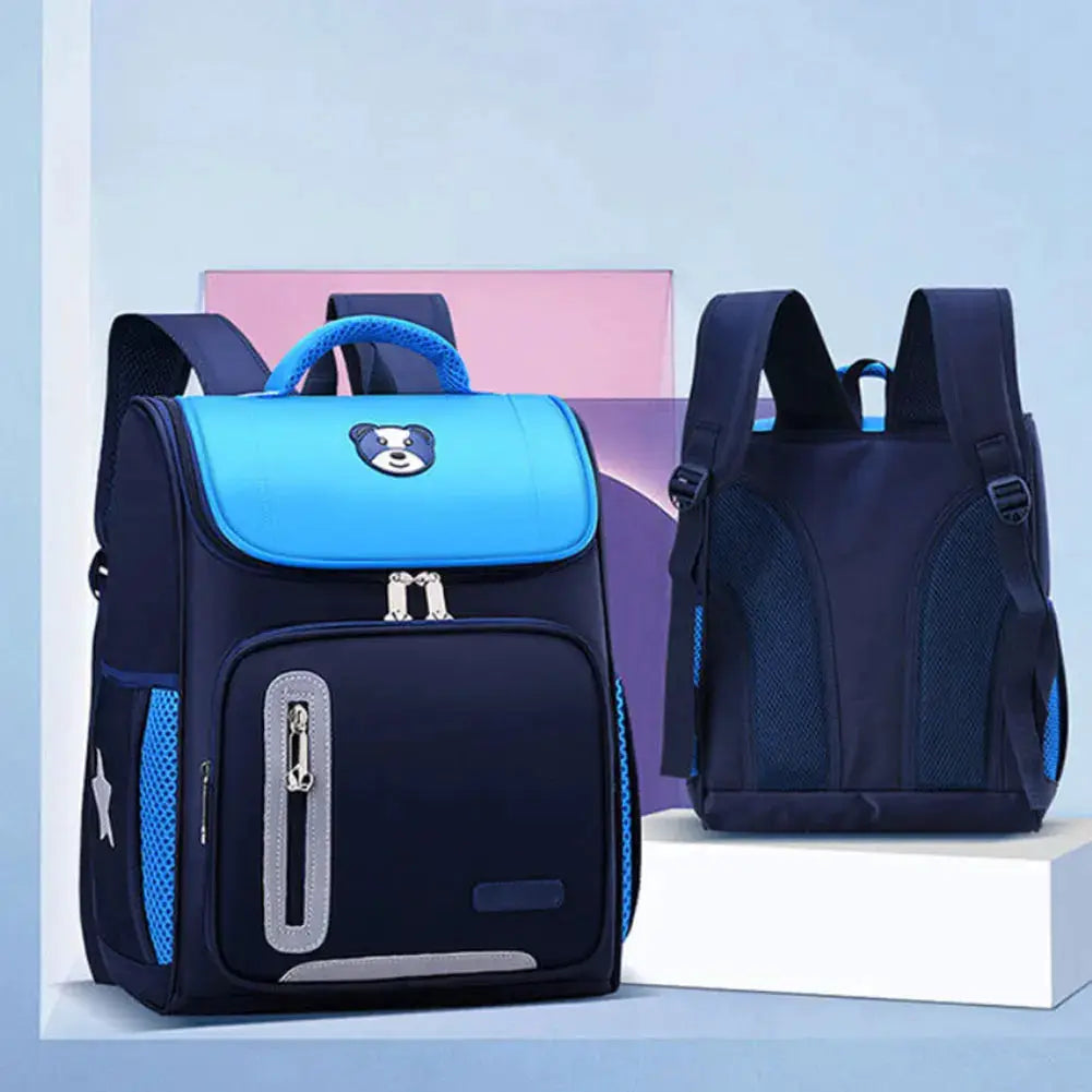 Two kids' navy and blue school backpacks with reflective accents and front zipper pocket