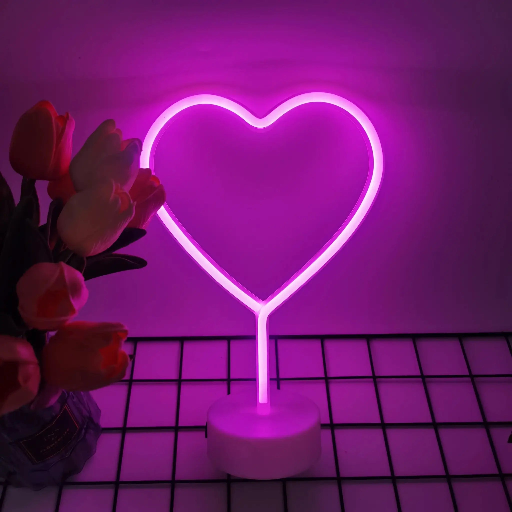 Heart-shaped neon light with pink glow; battery or USB powered, ideal for bedroom or living room decor.
