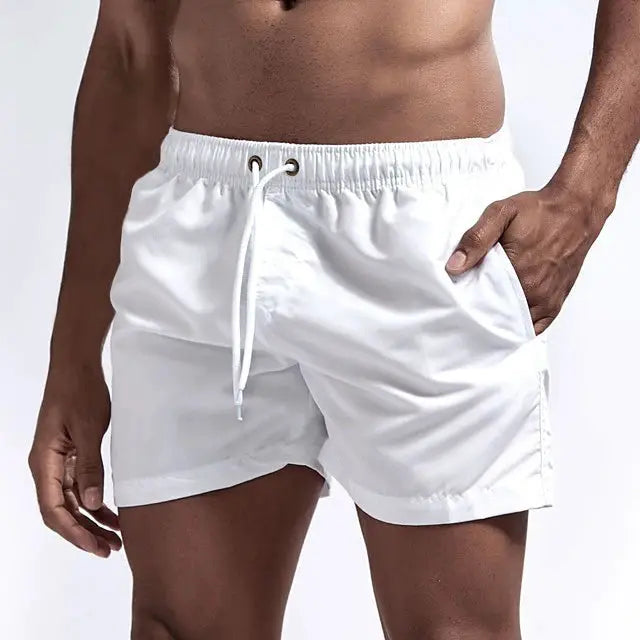 Men's white quick-dry swim shorts with drawstring and pockets.